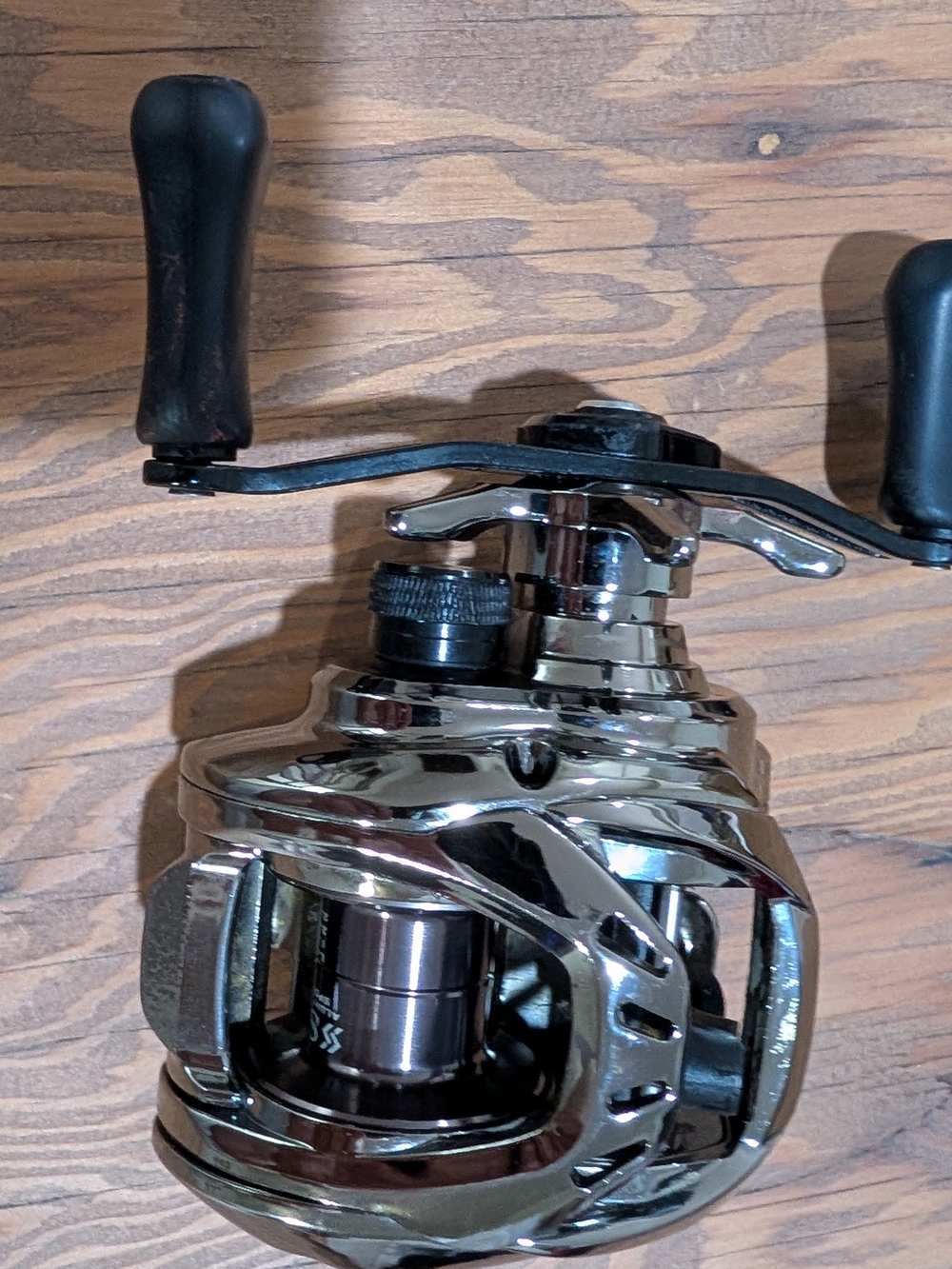 Chrome Baitcasting Reel with Black Handles - Sleek Silver Finish